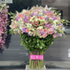 Large bouquet of pink and purple flowers with butterflies