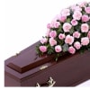 Pink roses and carnations arranged on a casket