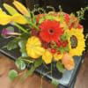 Bright mixed bouquet with sunflowers, gerbera daisies, roses, and calla lilies