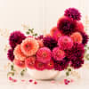 A sculptural celebration of dahlias in full splendor, this modern arrangement captivates