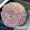 Large round bouquet of pale pink roses on a car seat