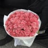 Large bouquet of pink roses wrapped in white paper