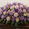 Lavender Serenity Casket Spray is a graceful tribute featuring lavender, purple, and