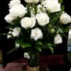White roses and white lisianthus in a glass vase