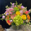Mixed bouquet in a glass vase with yellow roses and pink lilies