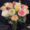 Bouquet of pastel roses and white chrysanthemums in a glass vase