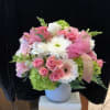 Pink and white mixed flower arrangement in a white vase