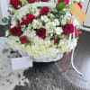 White basket arrangement with red roses and white hydrangeas