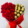 Heart-shaped box with red roses and gold-wrapped chocolates
