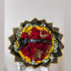 Bouquet of red roses and yellow sunflowers with a black ribbon
