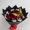 Bouquet of red roses with white baby's breath and a gold butterfly accent