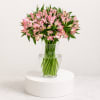 Soft clusters of pink alstroemeria and delicate white accents form a cheerful