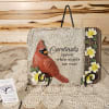 Decorative plaque with a cardinal and flowers on a stand