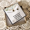 Gift box with two puzzle-piece necklaces and a printed card
