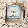 Gold necklace on a greeting card in a gift box