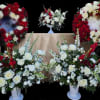 White and red rose funeral wreaths and arrangements on stands