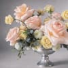 A refined arrangement of blush garden roses and champagne-toned spray roses, layered