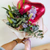 Bouquet of pink roses and lilies with a red heart balloon
