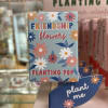 Decorative plant sign with daisy pattern and the words 