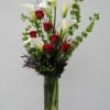 Tall vase arrangement with red roses and white calla lilies