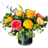 Mixed bouquet of bright roses in a dark glass vase