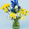 Bright, sunlit yellow tulip blooms ( seasonally made with rinanculus  or