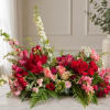 Low floral arrangement with red and pink roses and white blooms