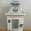 White decorative lantern with a metal handle and glass door