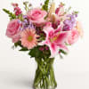 Soft pink roses and pink-and-white lilies mingle with pale peach gerbera and