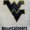 Quilted West Virginia Mountaineers logo on white fabric