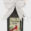 Black lantern with a white bow and a cardinal floral design