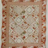 A cozy, country-inspired square quilted throw in warm burnt orange and cream
