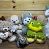 Assorted plush animals including teddy bears, a frog, a unicorn, and a dog