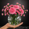 Serene Beauty is a graceful floral arrangement designed in a clear glass