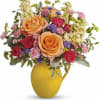 Pour on the sunshine! Filled with radiant roses, this cheerful yellow pitcher