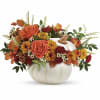 Autumn floral arrangement in a white pumpkin-shaped vase