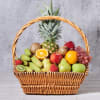 Wicker basket filled with assorted fruit and a pineapple centerpiece