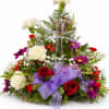 Floral arrangement with a clear glass cross and purple ribbon