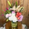 Mixed bouquet with lilies, roses, hydrangeas, and carnations in a vase