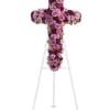 Purple and pink floral cross on a white stand