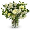 White and pale yellow flowers arranged in a clear glass vase