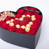 Heart-shaped box of red roses with gold chocolates and a tiara