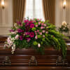 A sweeping horizontal spray of bright pink and magenta blooms makes an