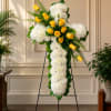 A reverent standing cross crafted for sympathy and funeral services, this floral