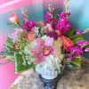A lush cluster of pink roses and a single large pink orchid