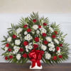 Large red and white floral spray with a red ribbon bow