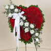 Heart-shaped red floral standing spray with white roses and a white ribbon