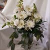 White gerbera daisies and snapdragons in a clear glass vase
