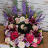 Mixed bouquet with pink lilies, roses, and purple flowers