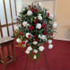 A traditional red and white standing sympathy spray.

Includes: Easel, Floral Cage, Robellini